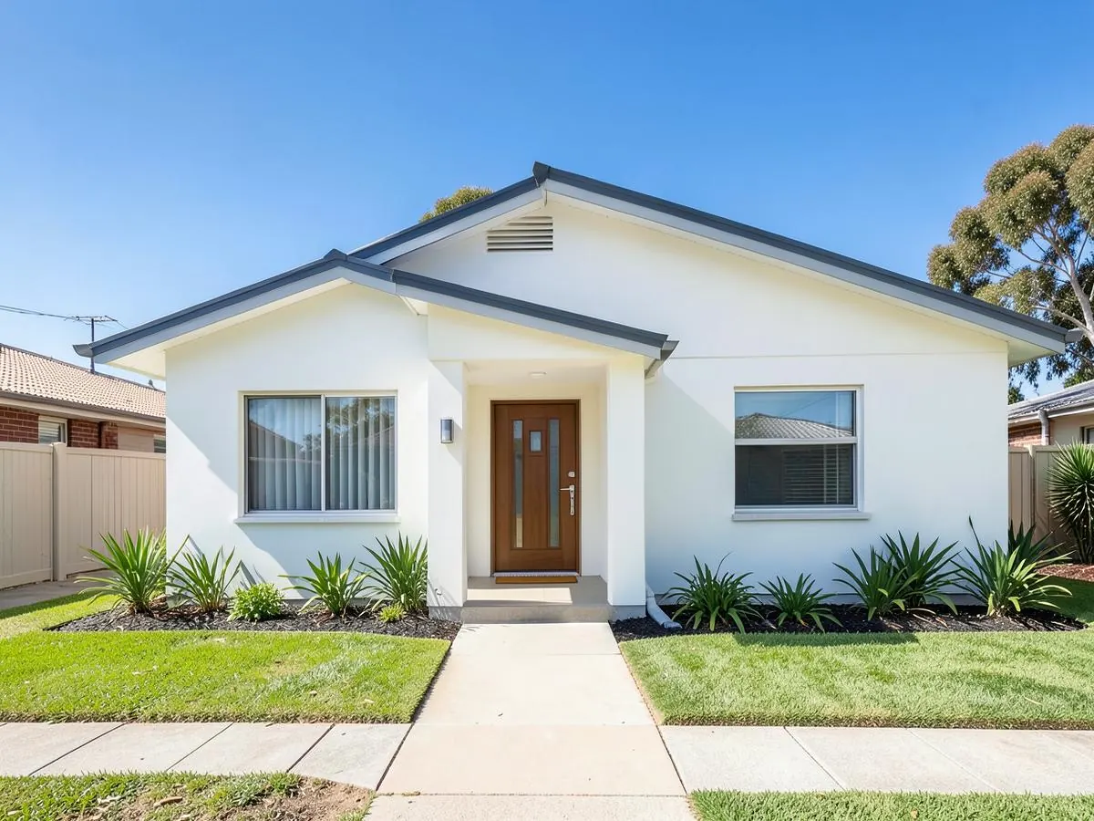 Freshly repainted white rendered home with charcoal roofline and trim under a clear South Australian sky